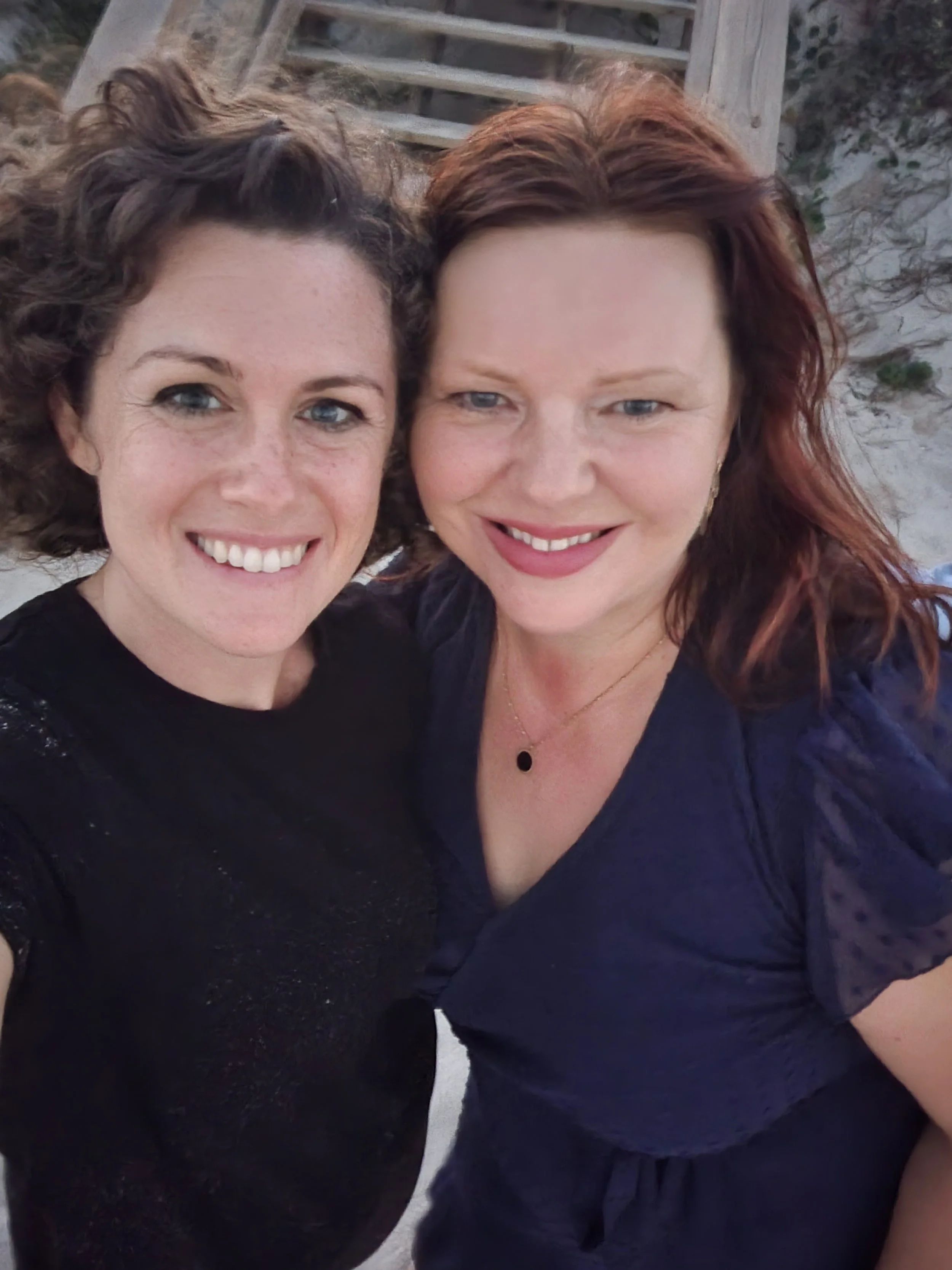 Best family photographer in St. Augustine FL at beach photo shoot with mom with sand and ocean in the background during sunset.