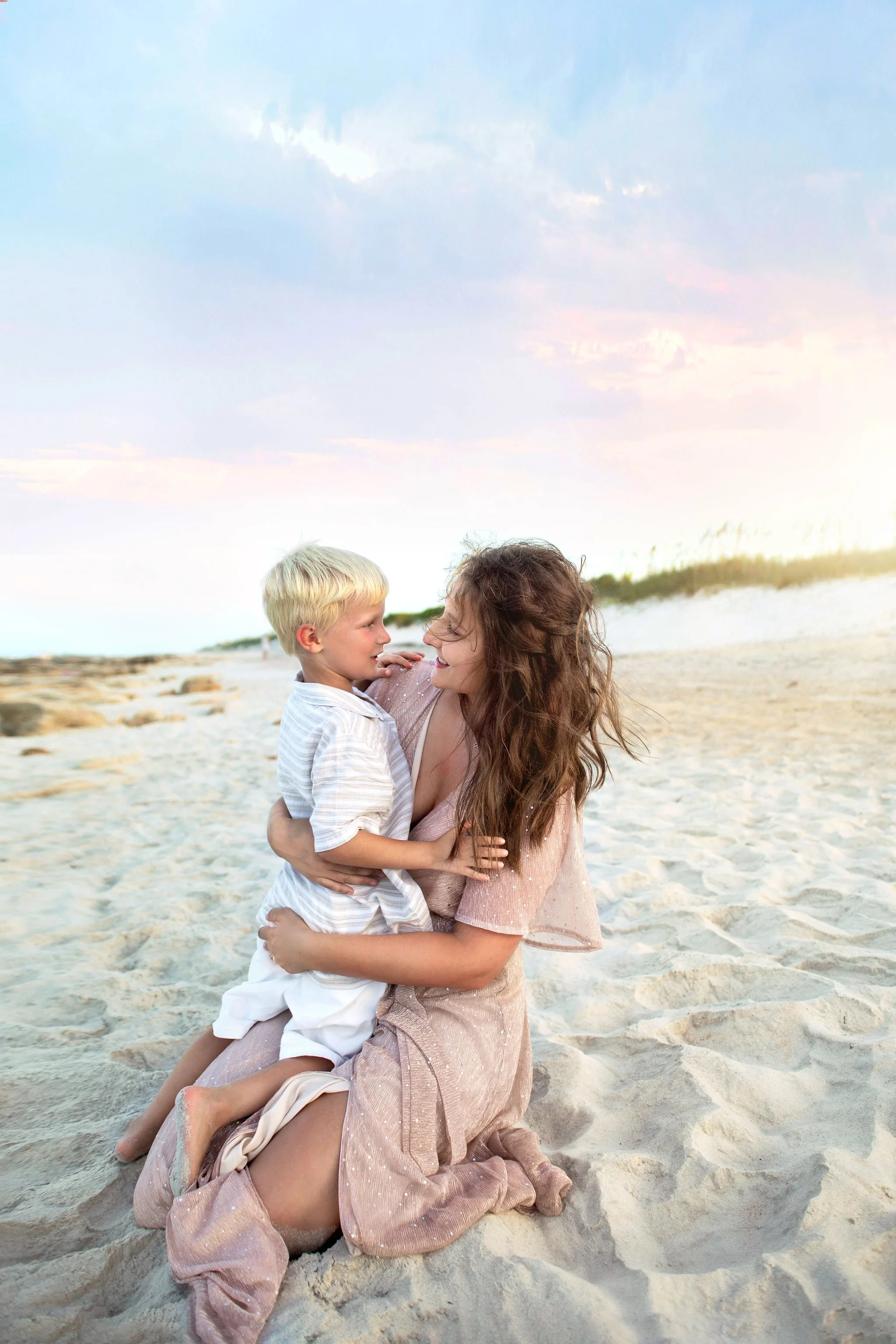 Best family photography in St. Augustine, FL with luxury photographer at the beach with mother and son at sunset with dunes