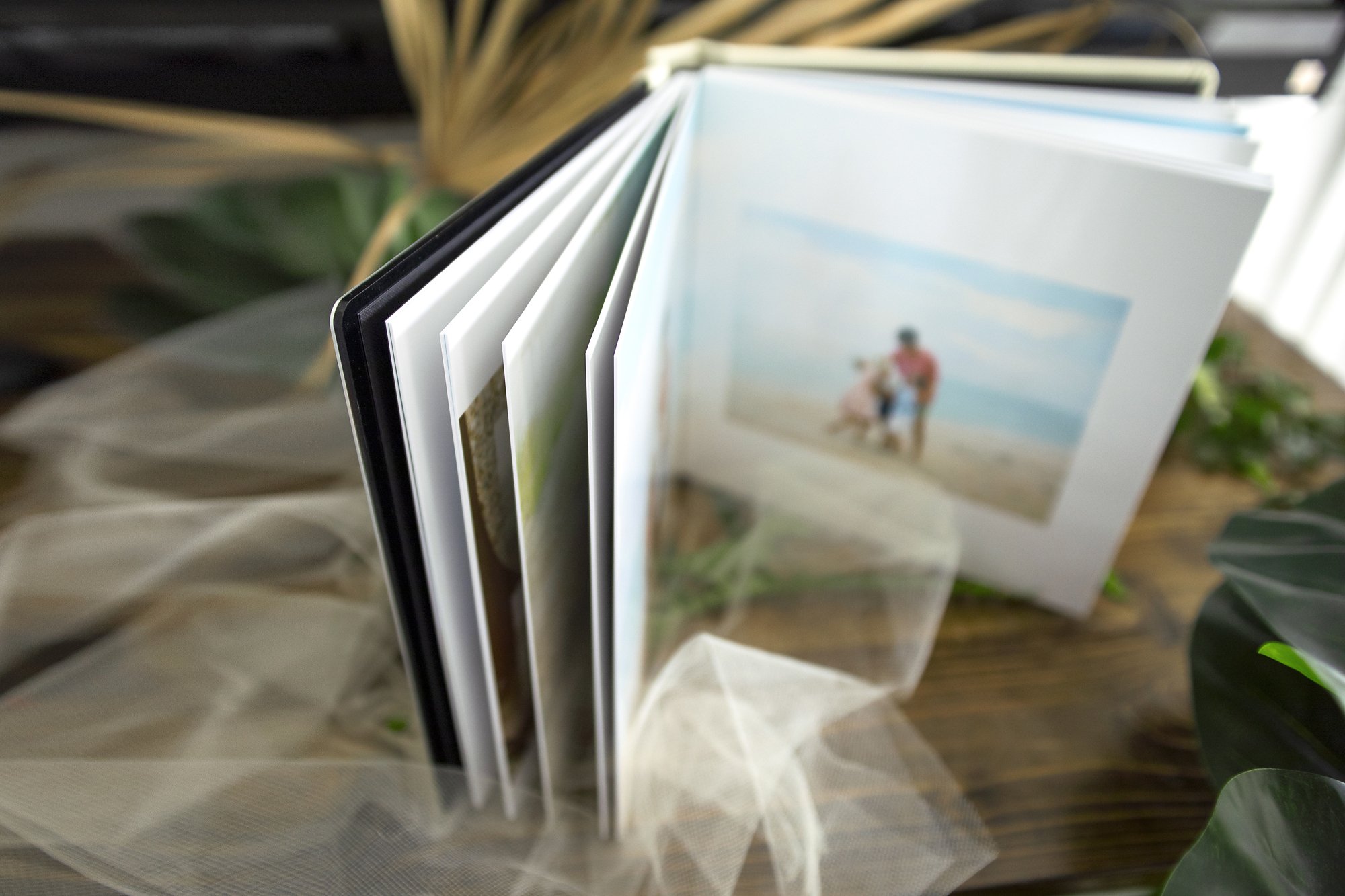 Photo album of St. Augustine family during photo shoot at beach near Ponte Vedra, FL with high end photographer.