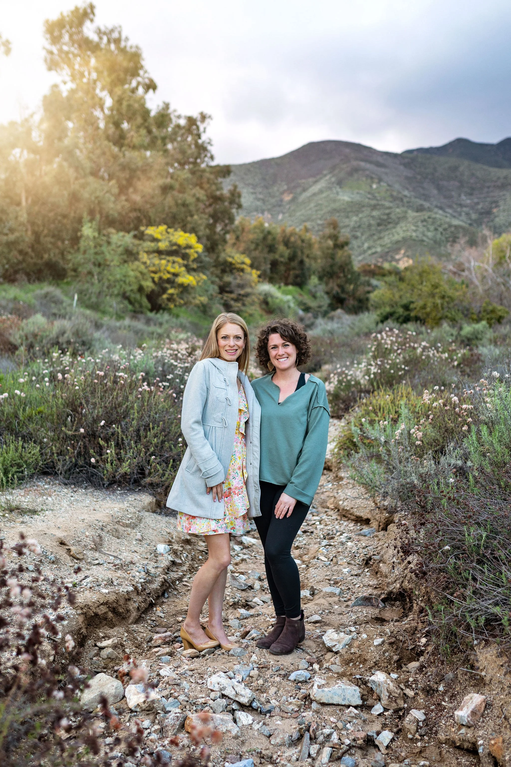 Best luxury family photographer traveling to Ponte Vedra, FL to do vacation photo shoot at sunset with greenery and rocks background.