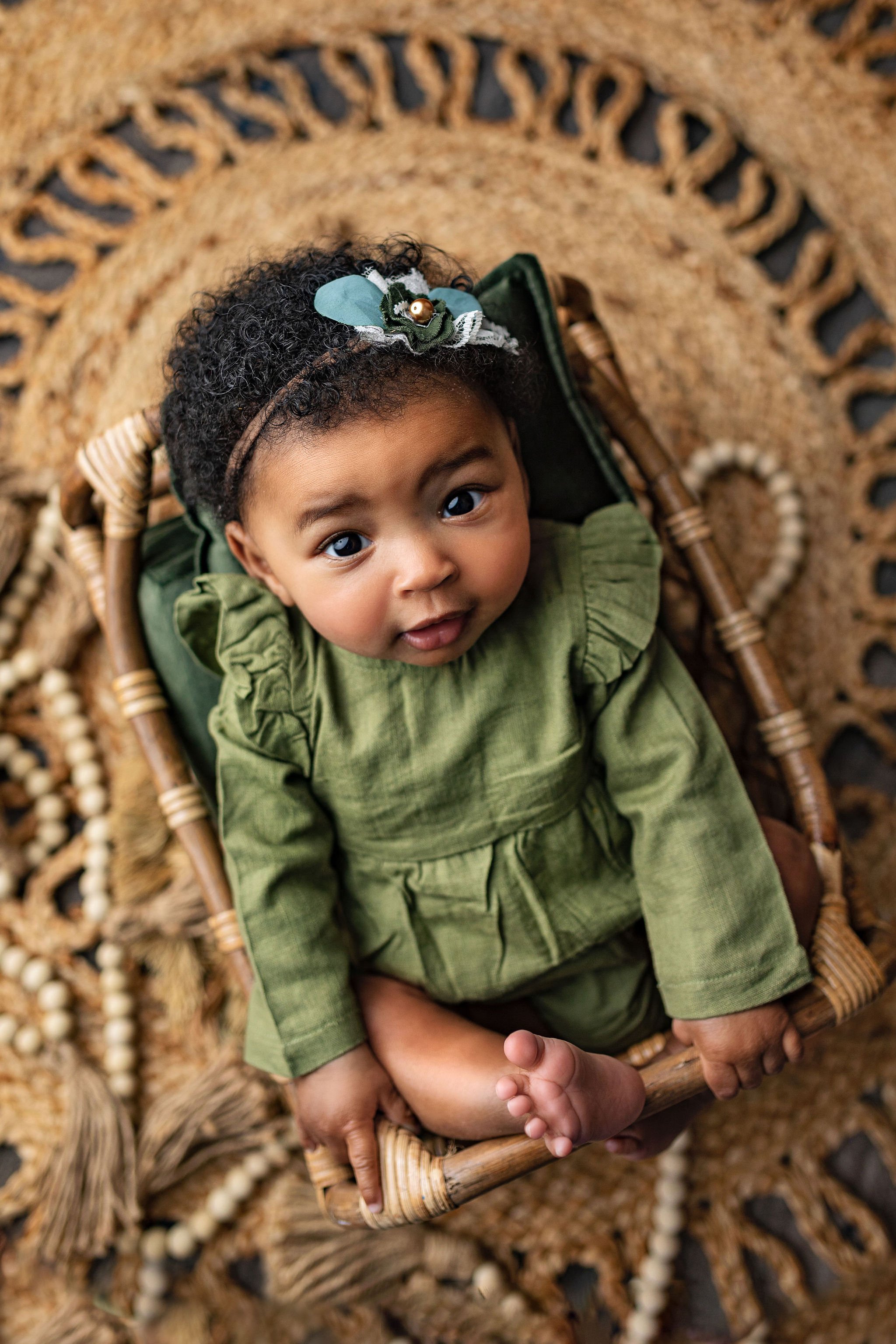 Jax FL best baby photographer in photo studio doing milestone session with 9 month black baby girl using earth tone boho bamboo props and rattan