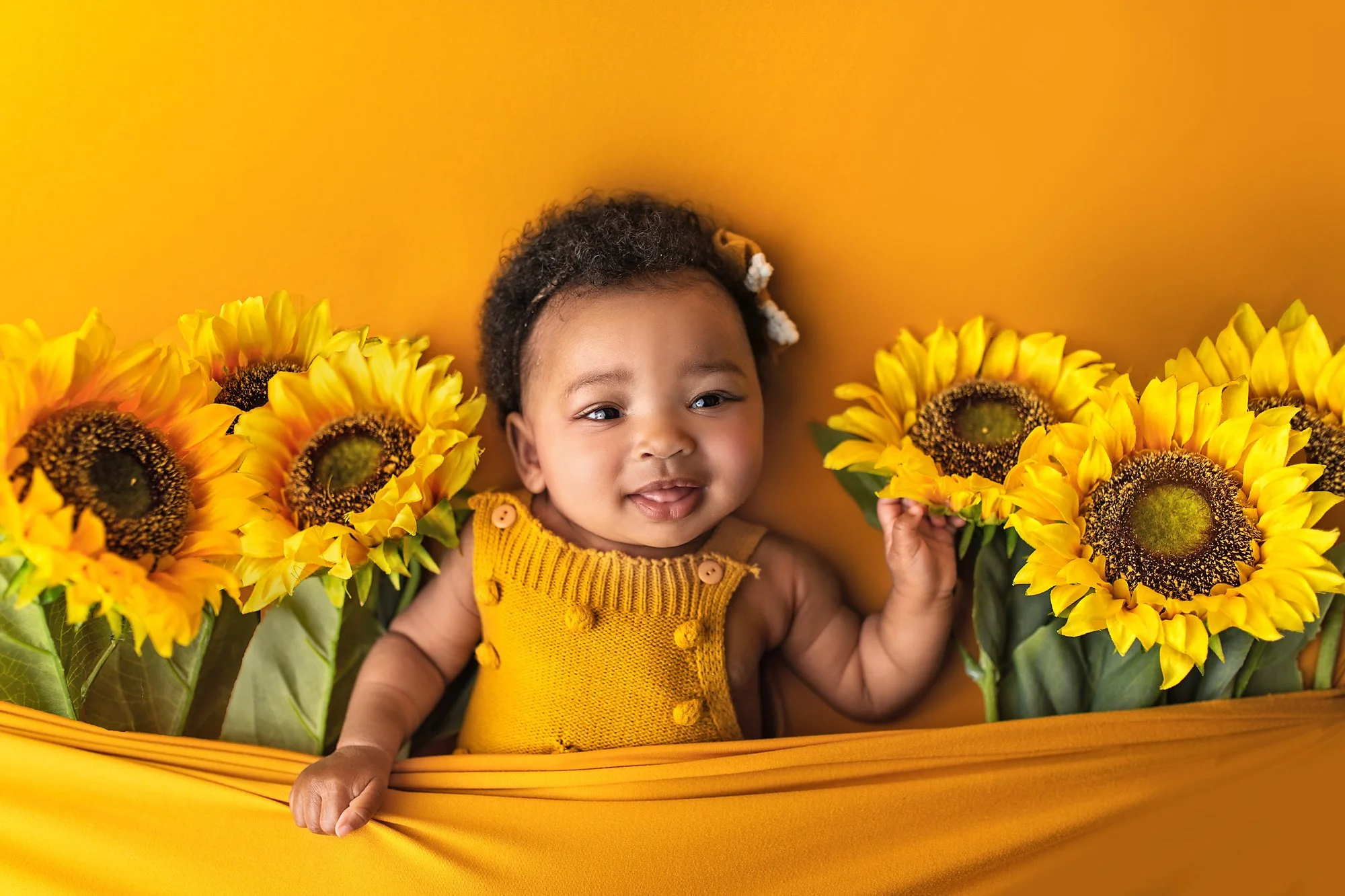 Ponte Vedra baby photo session with african american 6 month old for milestone photography with sunflower props and yellow background