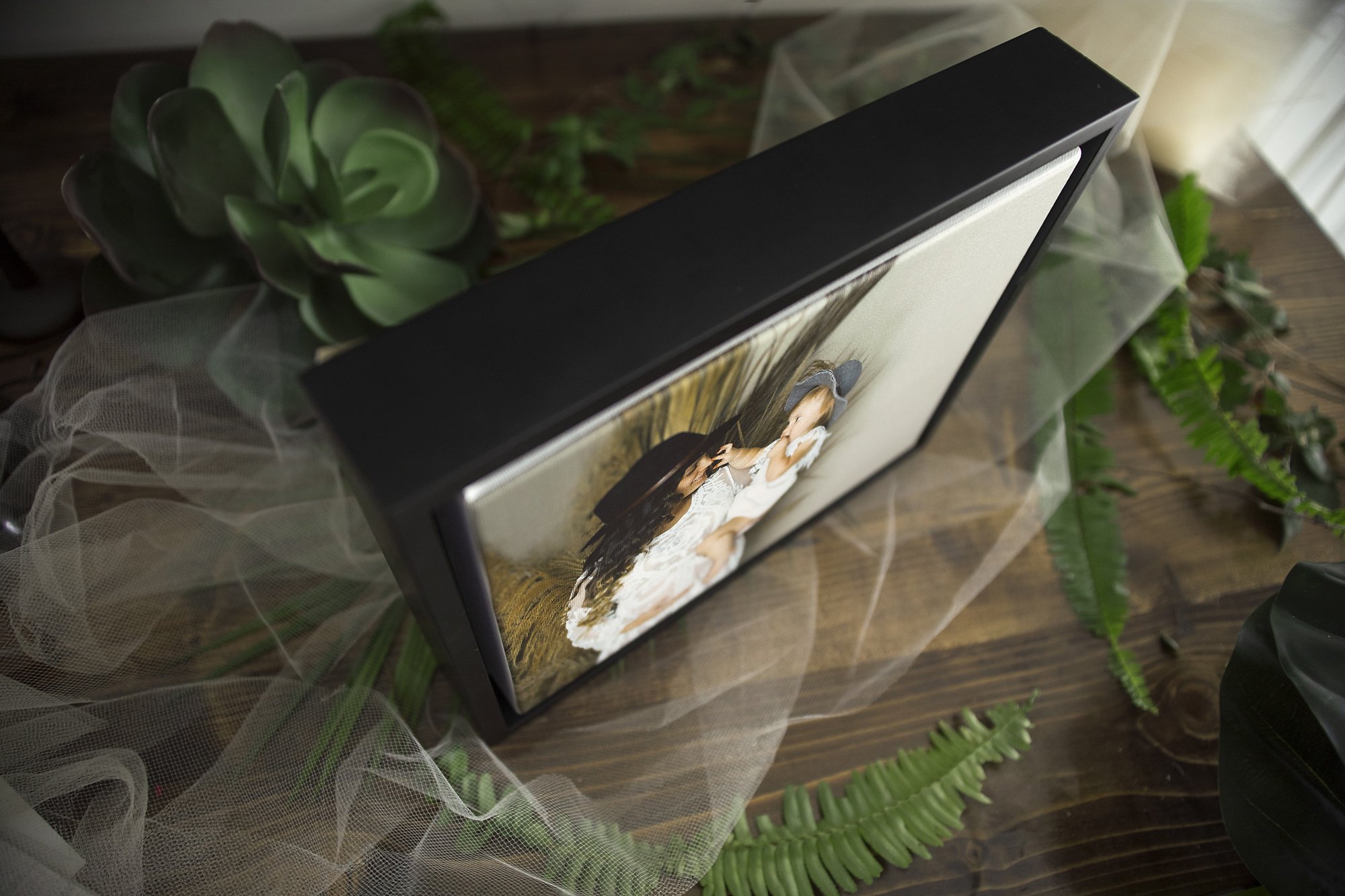 Framed photo of pregnant mom during maternity photo shoot in Jax, FL with modern baby bump photographer in photo studio.