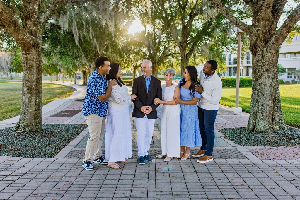 World Golf Village family photo session with best photographer with family in formal wear in coastal colors at sunset with oak trees and cobblestones