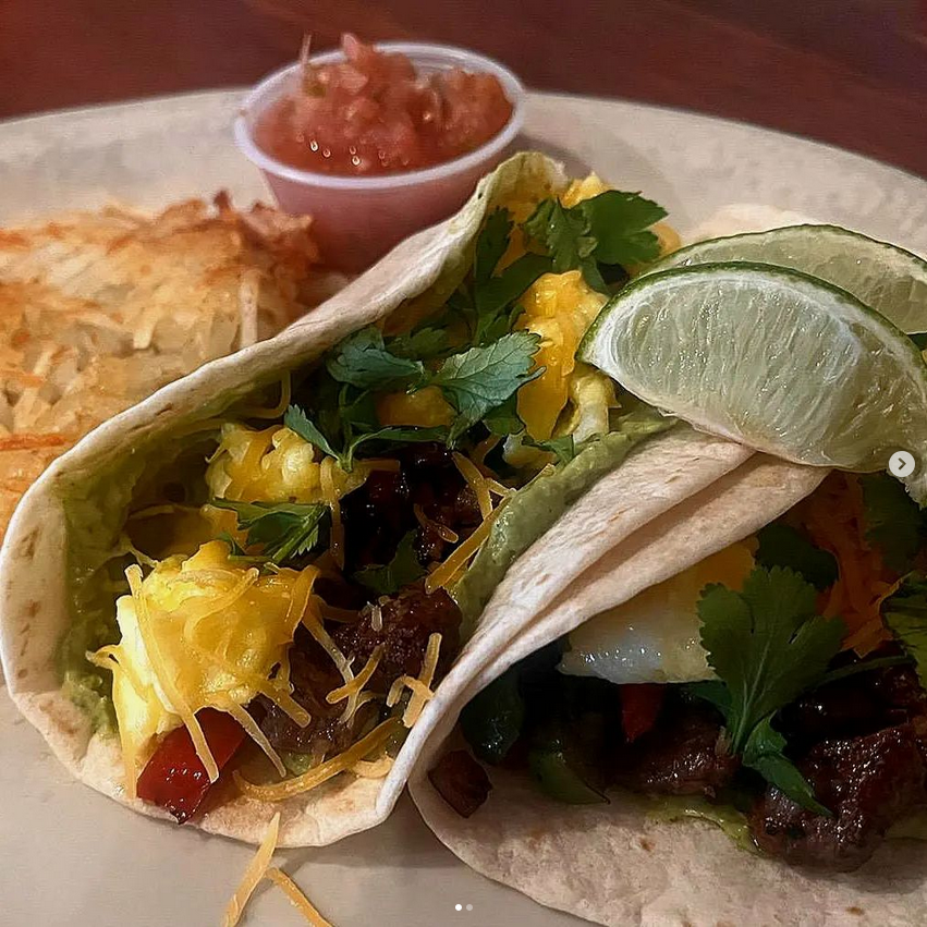 Steak and egg tacos with peppers, onions, avocado cream sauce.png