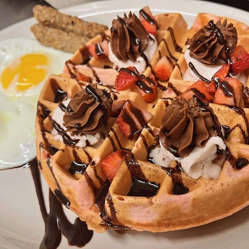 Strawberry waffle topped with chocolate mousse and fresh cream.png