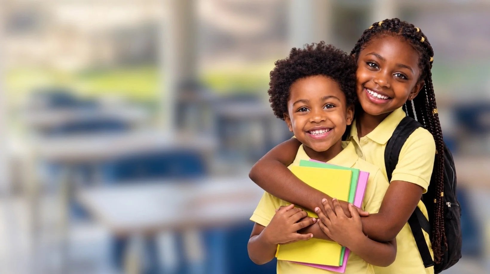 siblings dressed in school uniform smiling