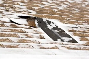 snow covered roof repair needed Parker roofing companies