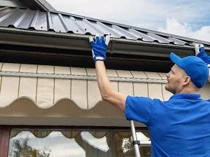 gutter system install Centennial roofing companies at work