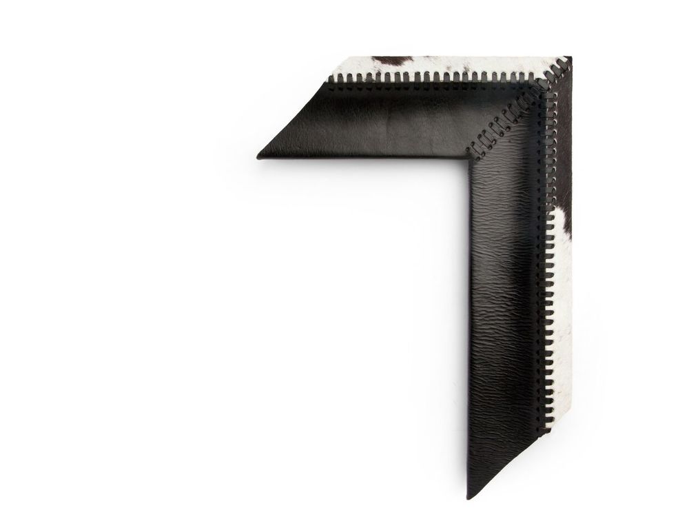 Cowhide Cove A 4 inch leather-wrapped frame, the outside edge is wrapped in alternating white-and-black cowhide and the inside cove in black leather, and is decorated with stitching along the corners and outer cove. There are many finishes and leathers to choose from, and no two are exactly alike.
