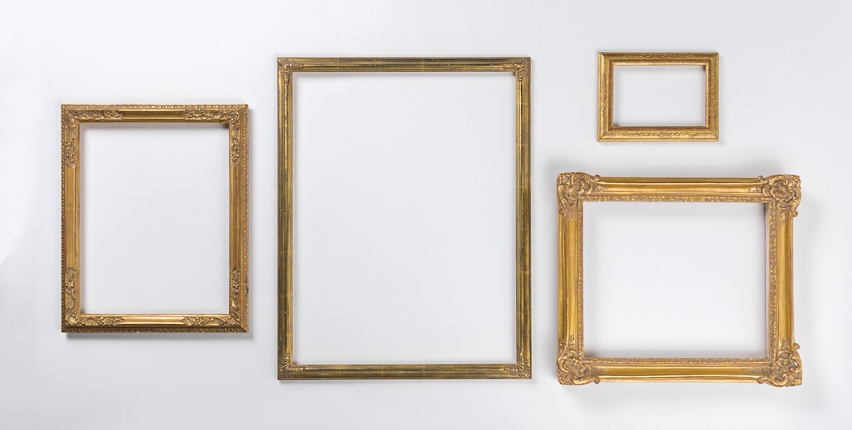 Four fancy picture frames laid out neatly