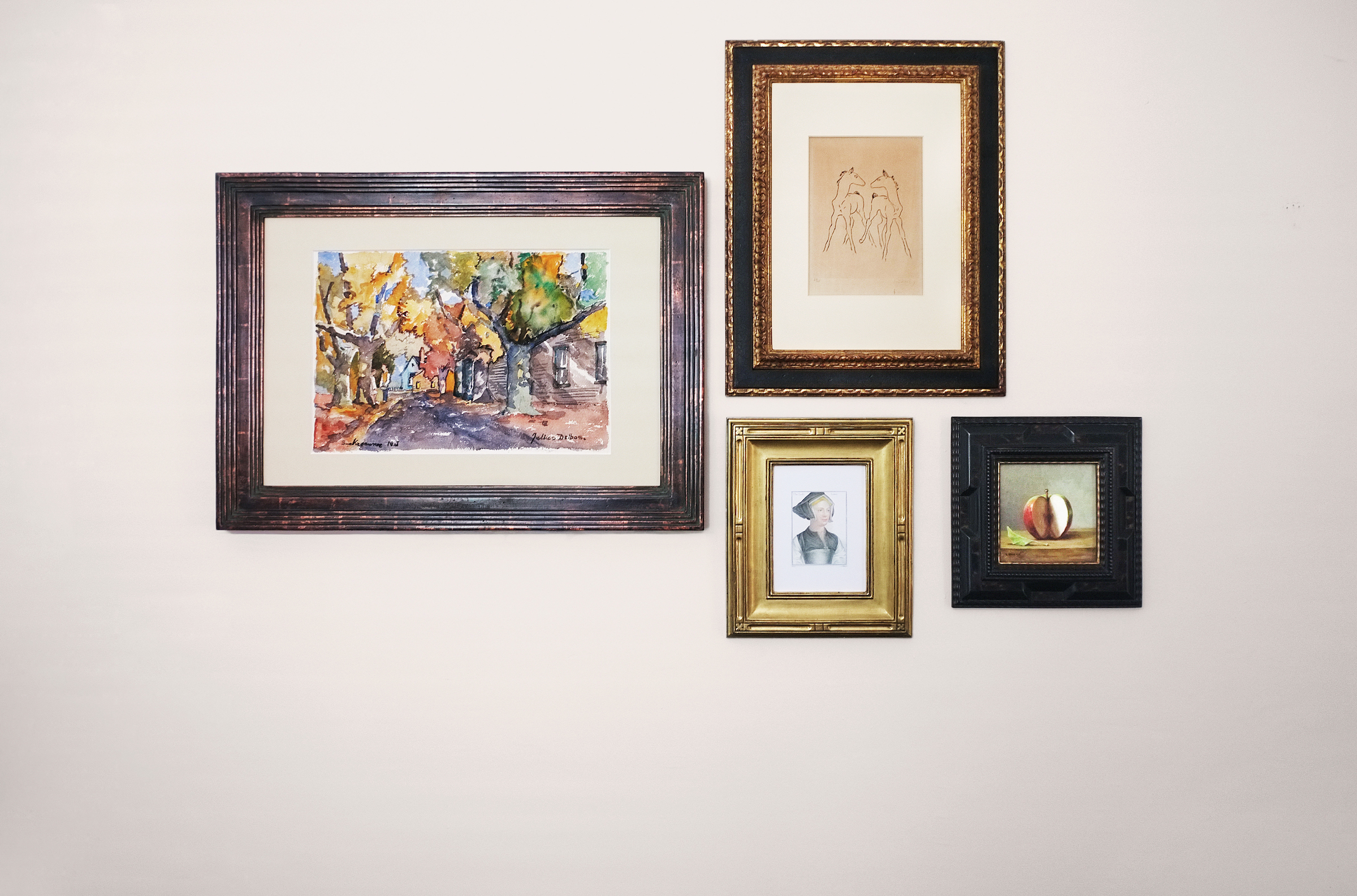 Four mounted picture frames with prints