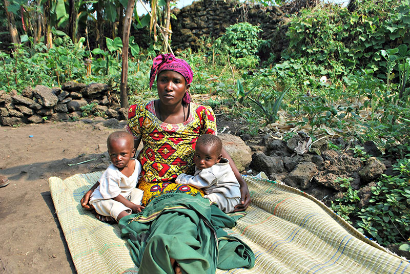 Anastasie and her children Claude and Claudette in her award-winning garden in Kimonyi.