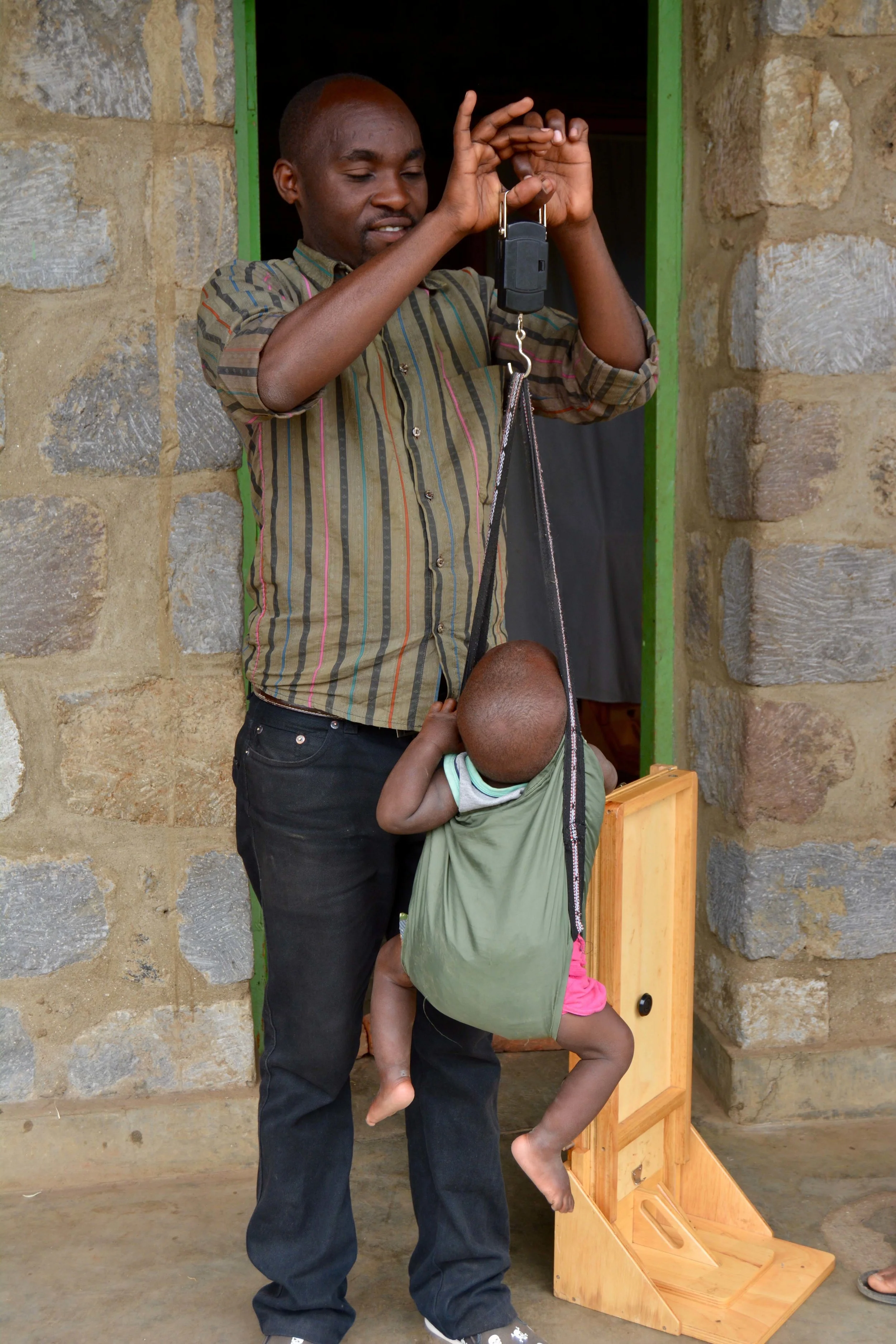 Monitoring and Evaluation agent Donation helps weigh children.