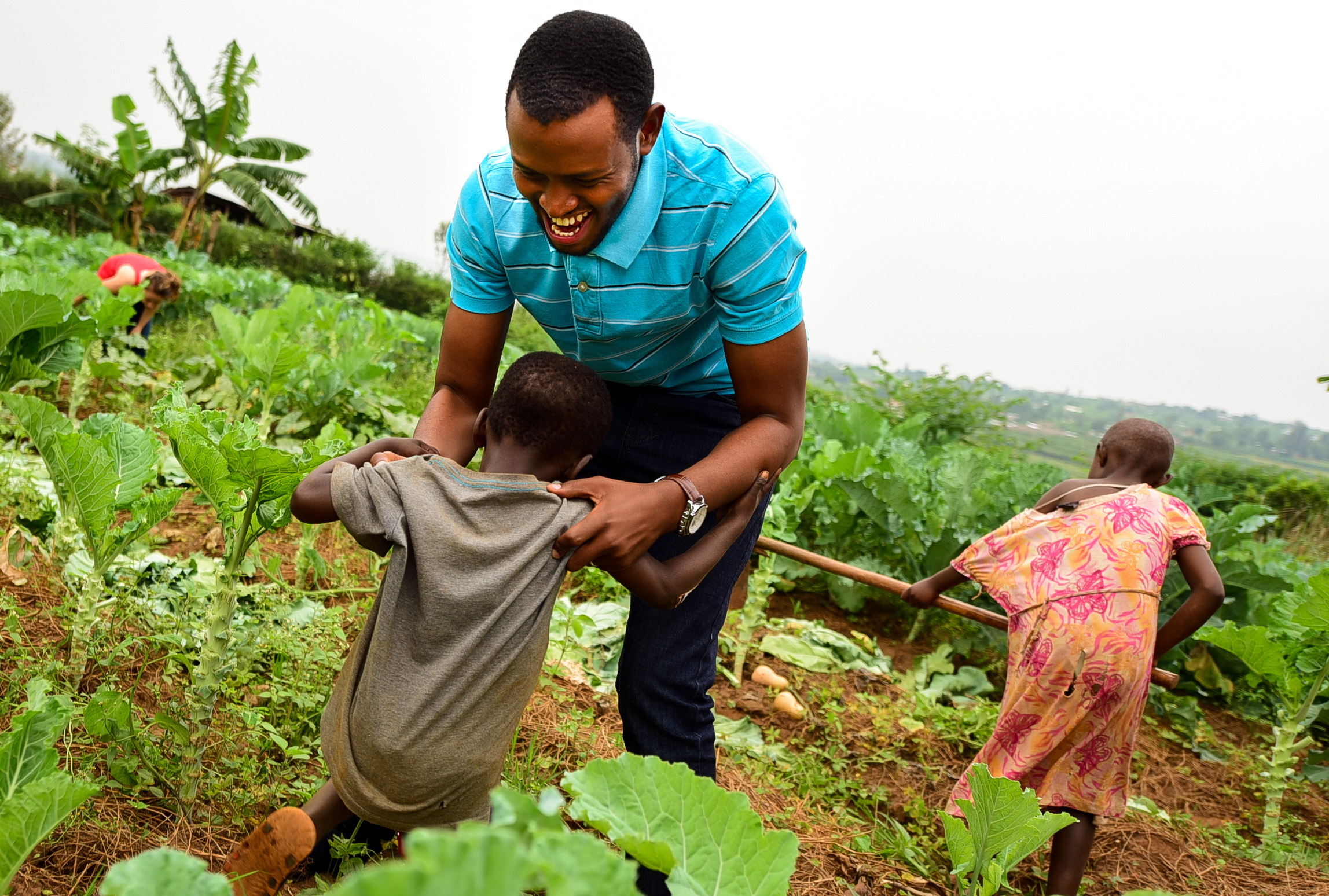 Solomon plays with Benja, a child enrolled in GHI's Early Childhood Development Program, during GHI's January 2018 Umuganda Day.