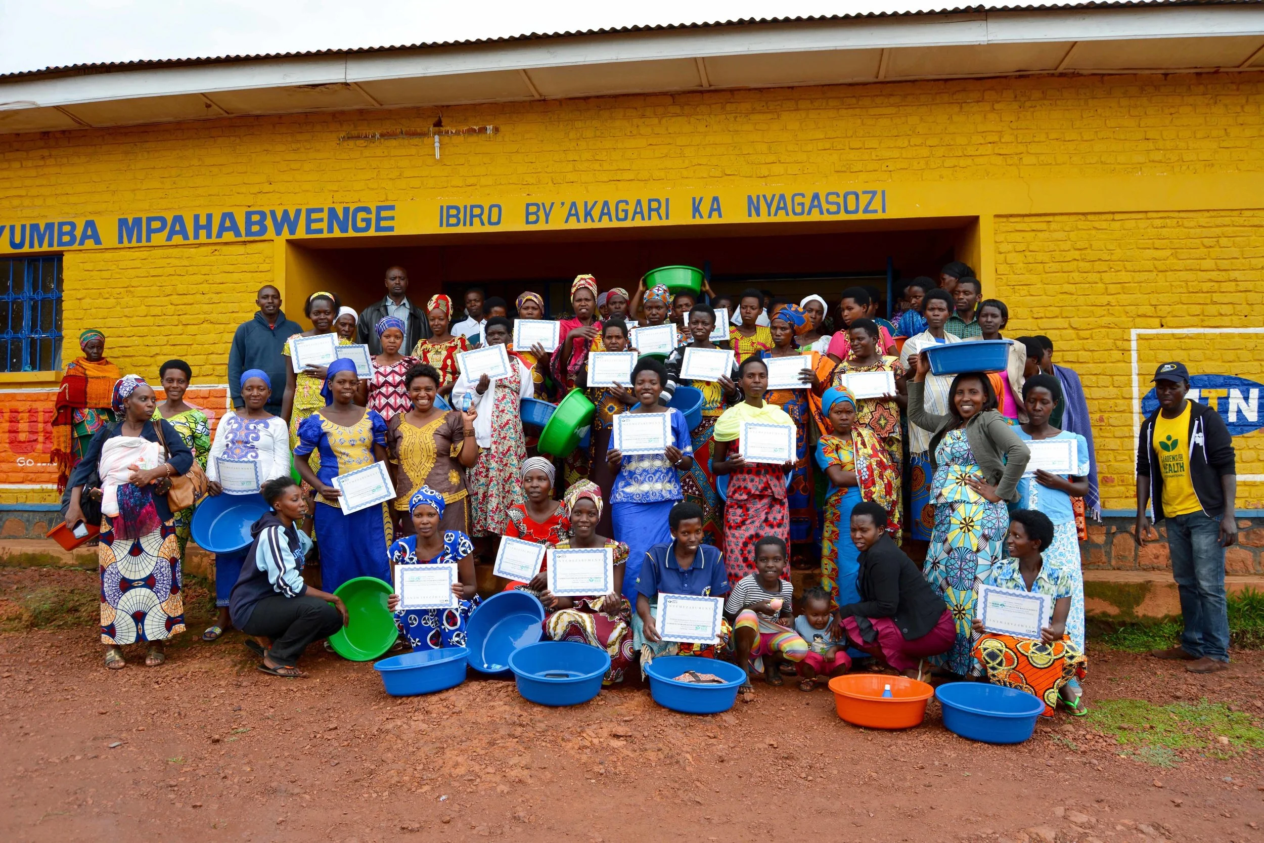 Claudine and her cohort proudly show their certificates.