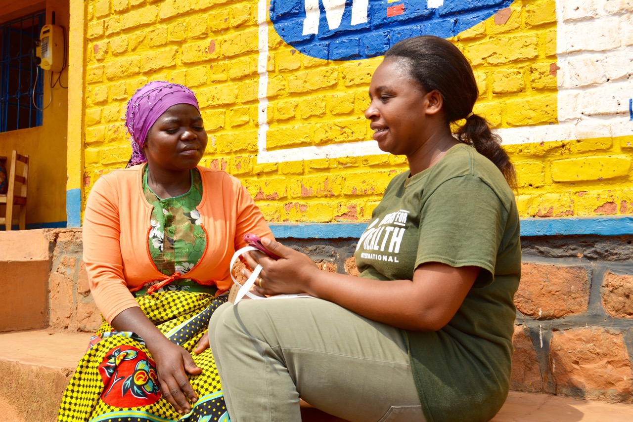 Esperance, Gasbao Field Educator, meets with a caregiver.