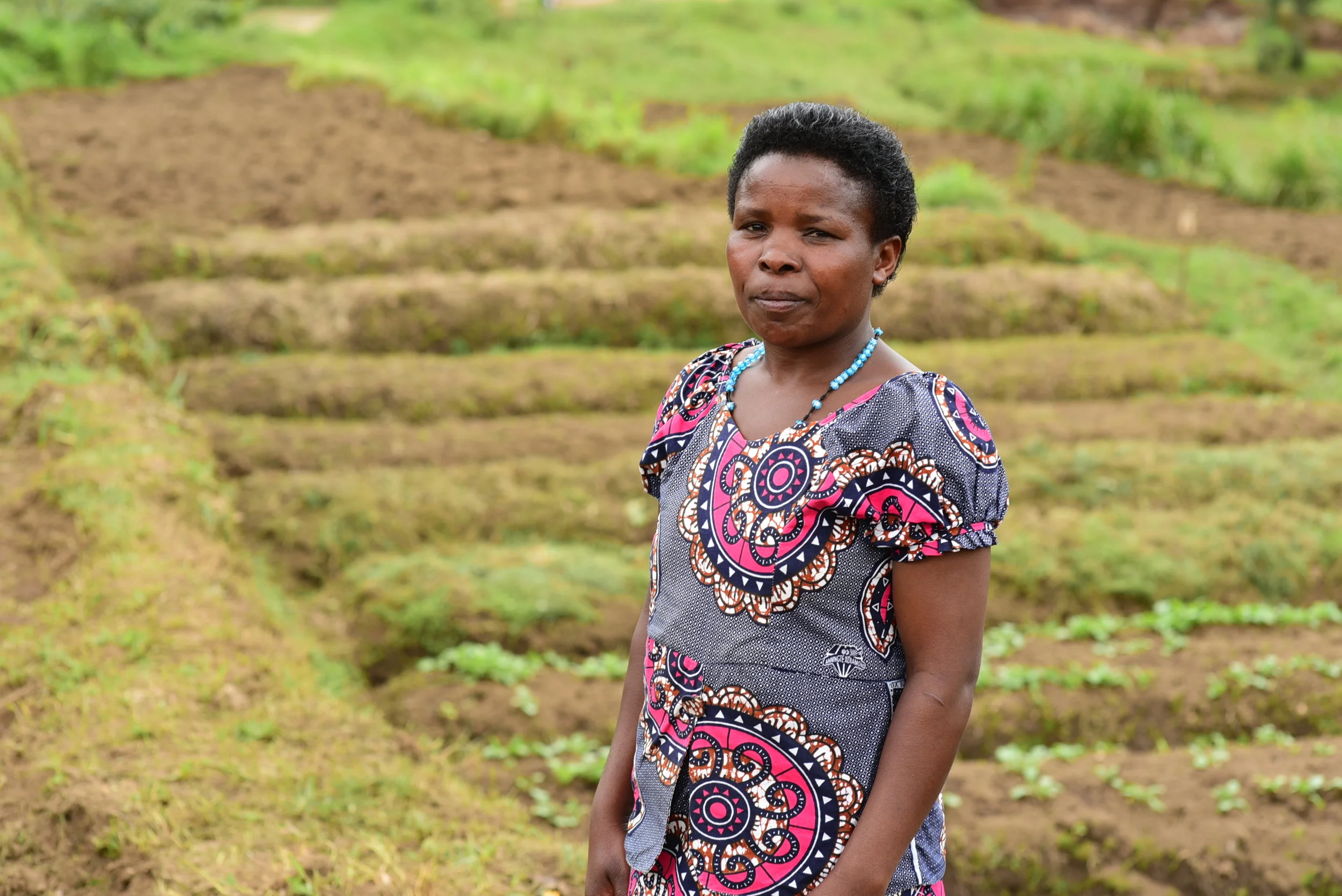 Nyirabukeyengenda Marguerithe in front of the EP Rutsiro garden in March 2018.