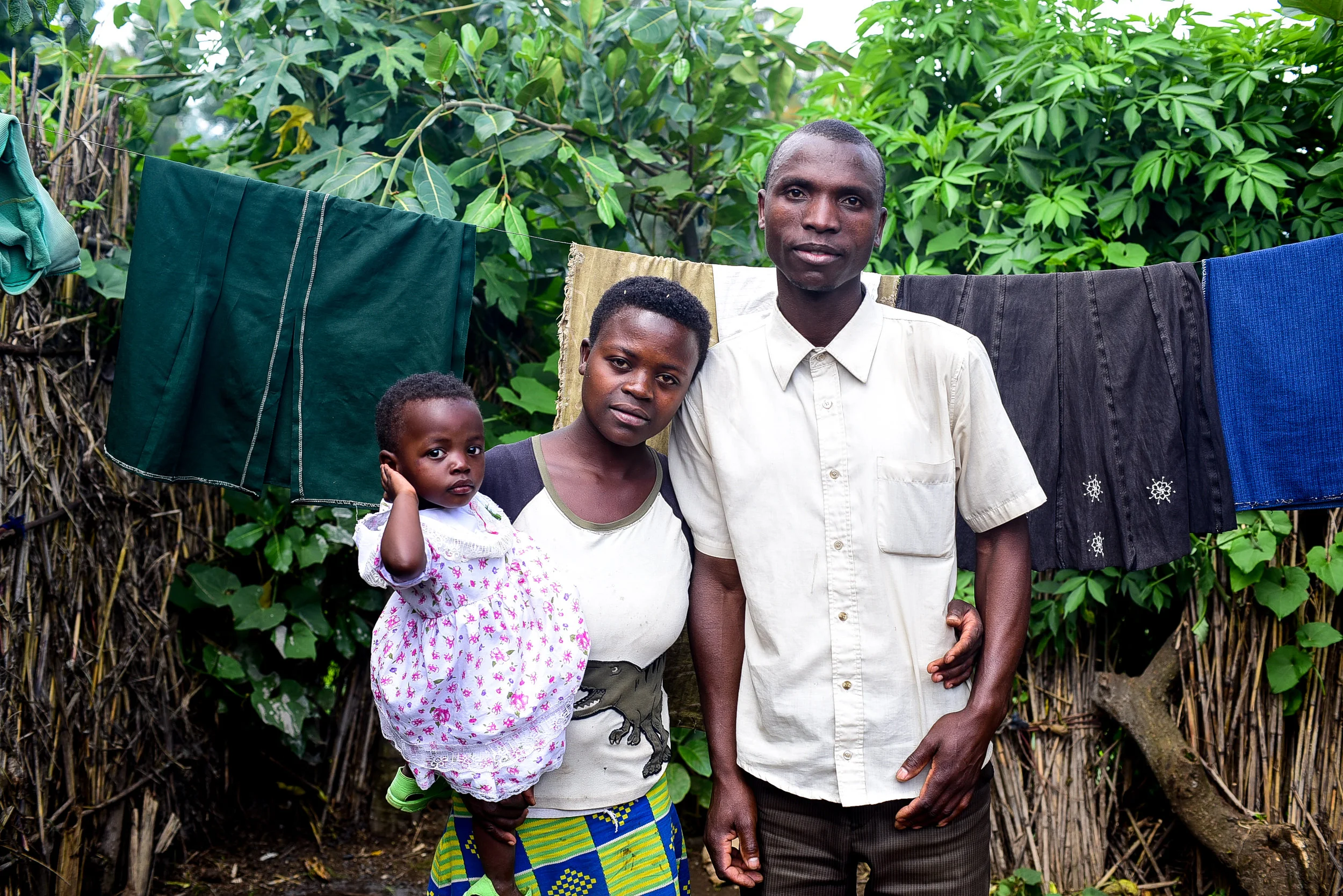Family portrait of Jeanne, her husband, and daughter at home on