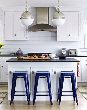 Add some style with clean cabinet finishes, like this beautiful white-on-white kitchen with artistic yet simple knobs.