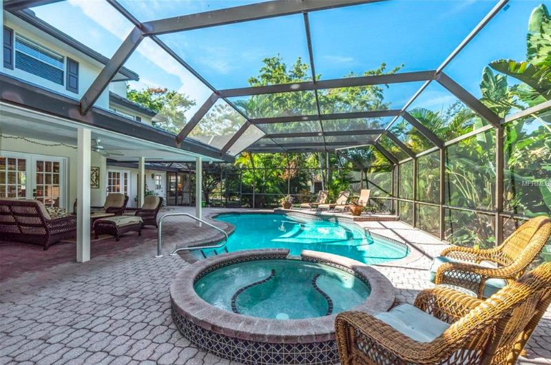 The large lanai holds an in-ground heated pool and attached spa, as well as plenty of room for lounging or entertaining, perfect for year-round enjoyment of the beautiful paradise setting.