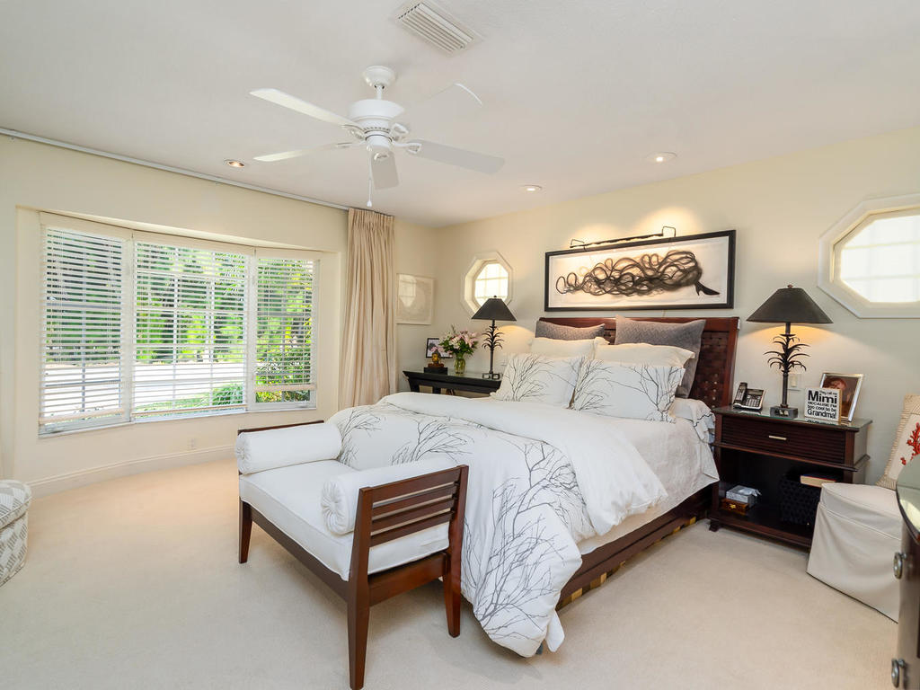 A peaceful master suite is bright thanks to large bay window and features a beautiful tone-on-tone ensuite bath as well as a customized walk-in closet with motion-detected lighting.