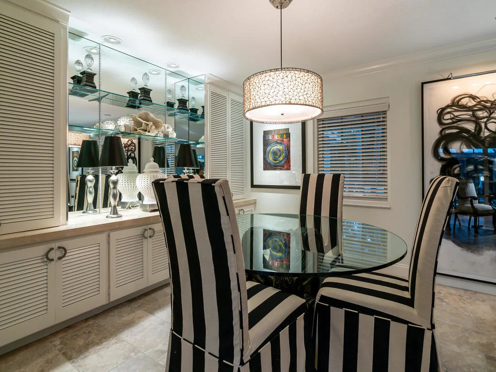 Sleek built-ins and open shelving provide storage and display space in the dining area.