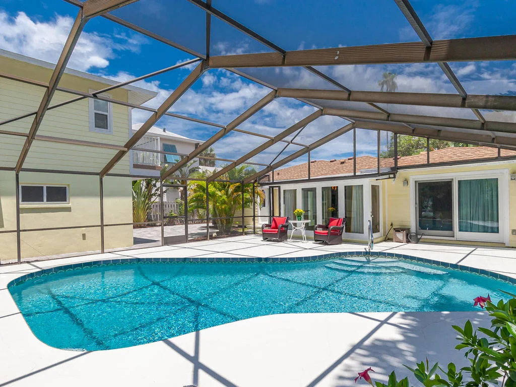 The spacious outdoor area is easily accessible from both the main and guest houses and features plenty of space for entertaining, sunning, or just floating around enjoying the rays.