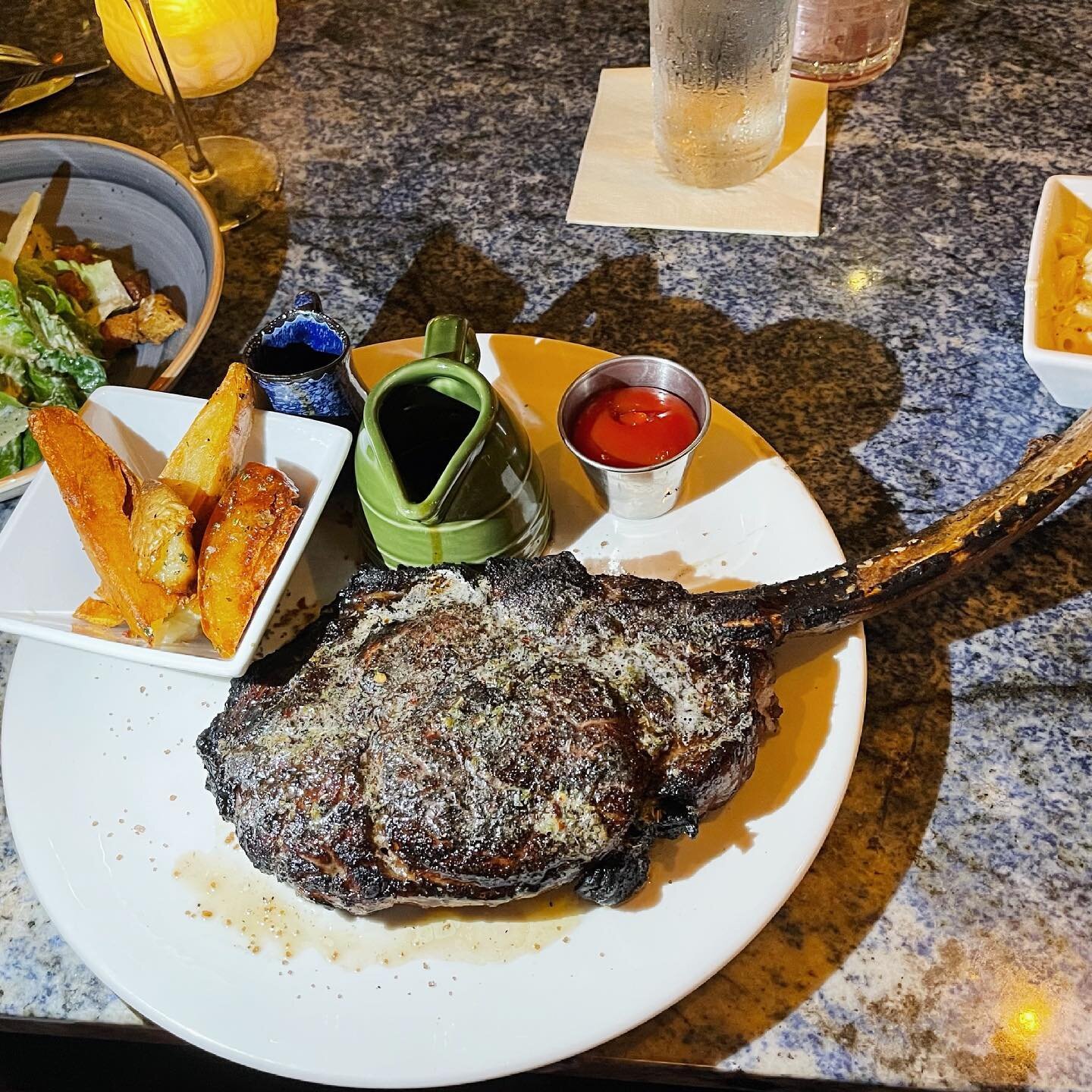 On special until further notice is this 28 oz Tomahawk bone-in steak that&rsquo;s served with our Village Salad, Mac and Cheese, and Steak Fries🔥🤯