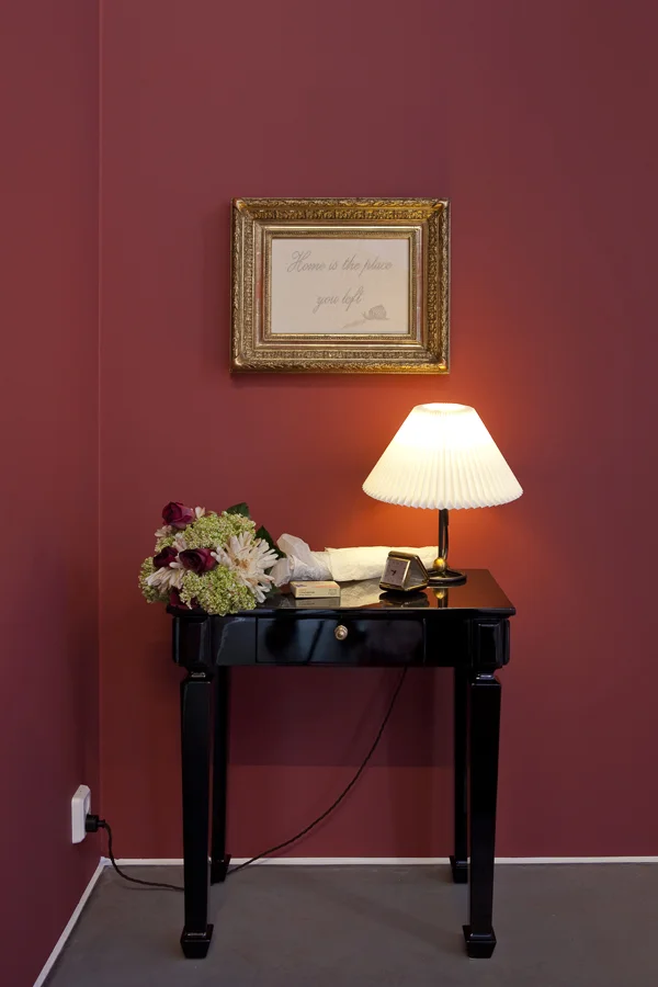 Elmgreen & Dragset Home is the place you left (2014) Wooden table, framed embrodery, textile flowers, clock, vintage Klint lamp, citalopram antidepresant, c-print in drawer