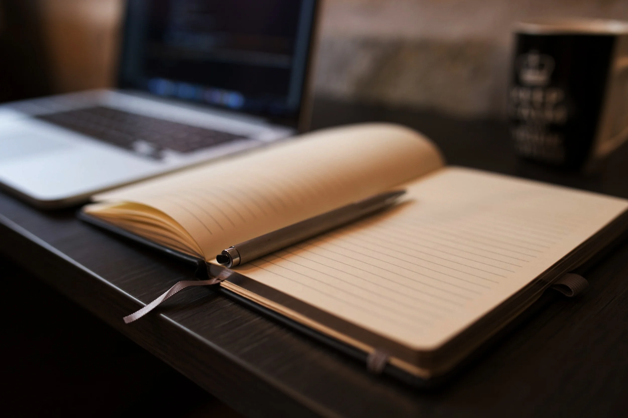 notebook-and-ballpoint-with-laptop-in-background.jpg