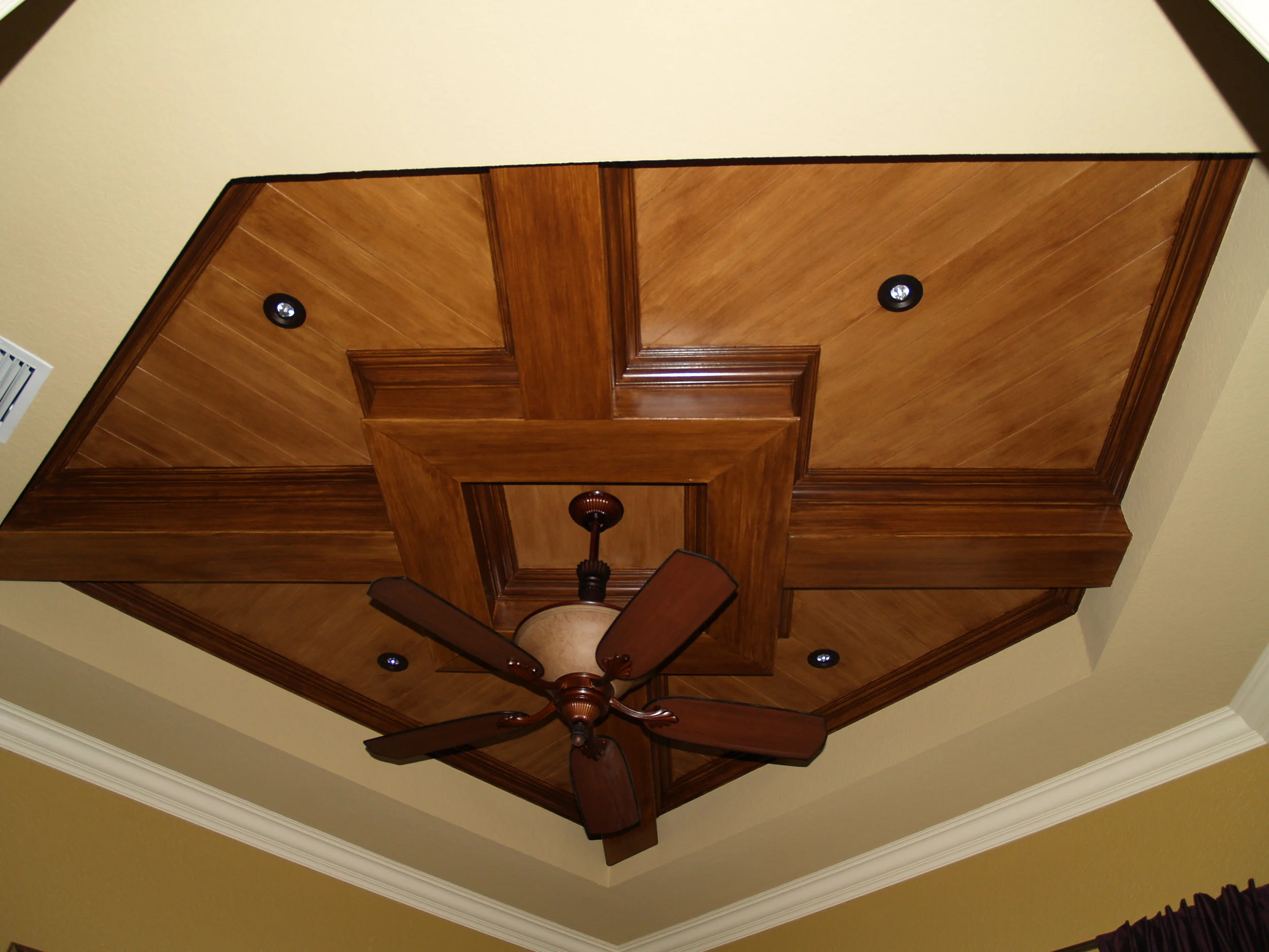  Custom design and finish created to address an unusual 5 sided tray ceiling. 