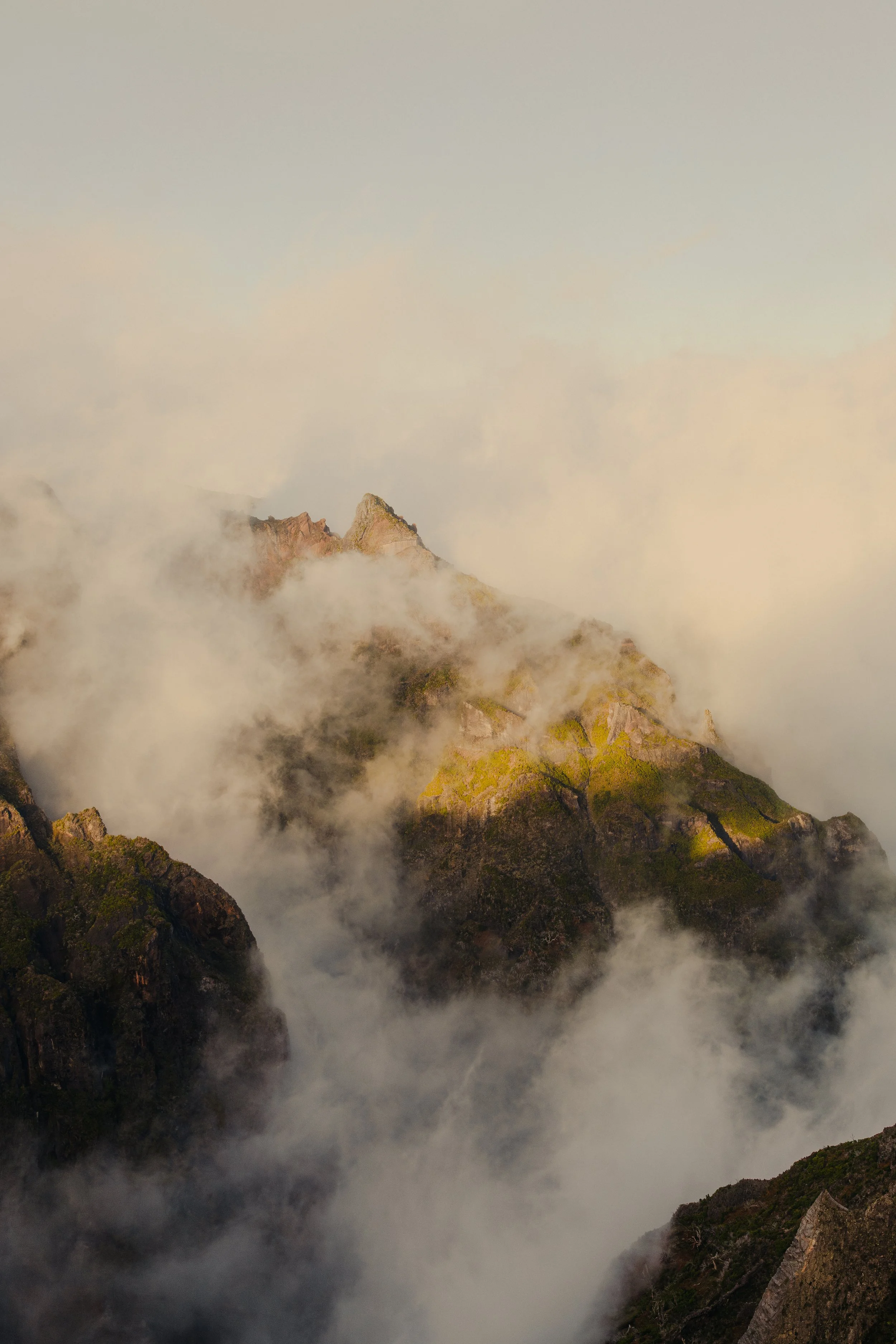 Mist floating across the mountains of Madeira at golden hour