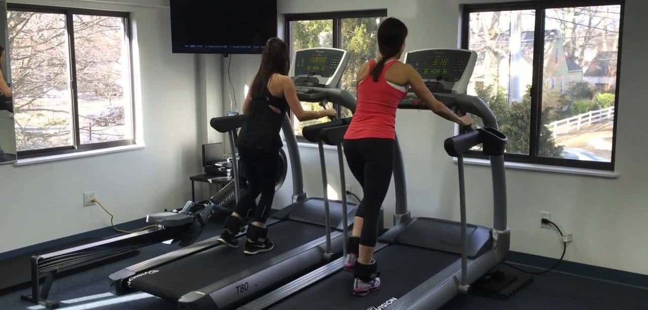 women walking on treadmill back turned.jpg