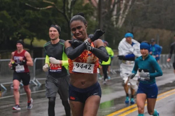 Dannielle gives the "Wakanda Forever" salute as she braves icy rain at the 2018 Boston Marathon. Photo: Samuel Okpakoh Ayide