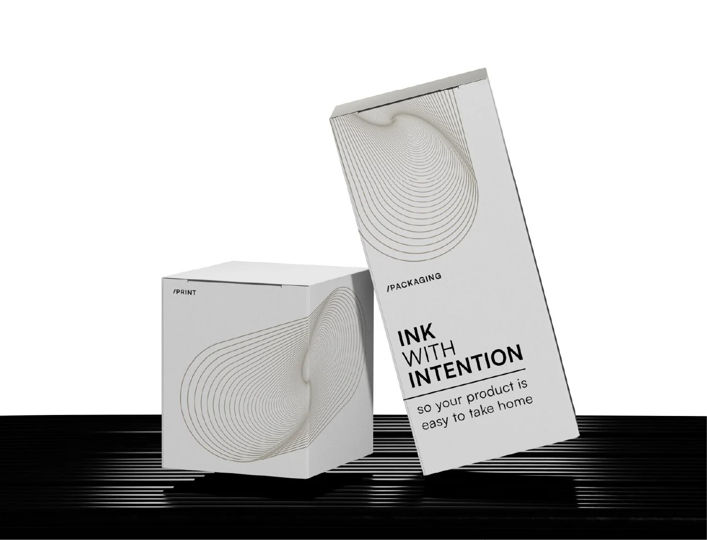 Two white boxes with abstract line designs and text, one standing and one lying down, on a black textured surface