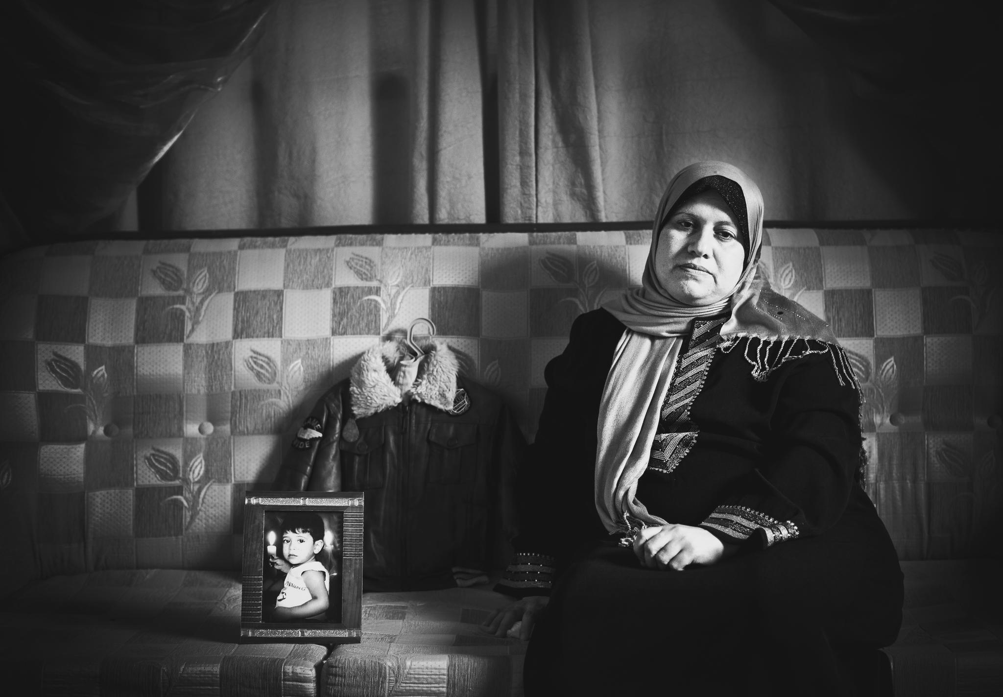"when you lose your child,, you become a brokenhearted woman till infinity,nothing more, much less." Entesar Hamouda,43 years old, sits next to her son Feras Hamouda’s photo and the jacket he last wore before getting killed at the age of two during the first war on Gaza, January, 2009. For 20 years Entesar's attempts to have a baby had failed. Finally, after suffering her third miscarriage, she decided it was time to give up and let go of her dream of motherhood. Miraculously, only two moths later, she discovered she was pregnant with a baby boy. Feras was born in 2006, but devastatingly killed just 25 days after his second birthday. © Images by Eman Mohammed | Broken Souvenirs series.