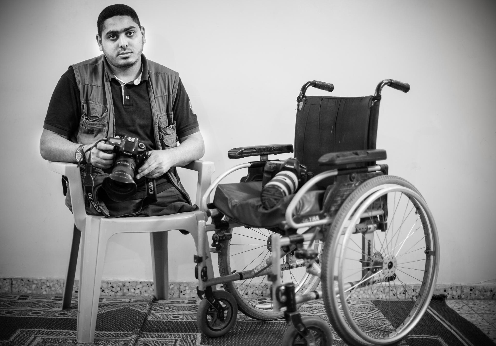 "amputating both of my legs only made my way to achive my dreams harder and full of obstacles, but it didnt end it, amputating my heart would,not my legs" Moemen Moemen Faiz, a Palestinian photographer and visual artist, is sitting next to his wheel chair and two cameras. Moemen lost both of his legs on Eid Al Adha evening during an airstrike on his neighbourhood. Moemen went to Saudi Arabia to seek treatment hoping to be fitted for artificial limbs, but the critical condition of his amputations at the time disqualified this possibility. He now presses on with his work as a photojournalist from the confines of his wheel chair. © Images by Eman Mohammed | Broken Souvenirs series.
