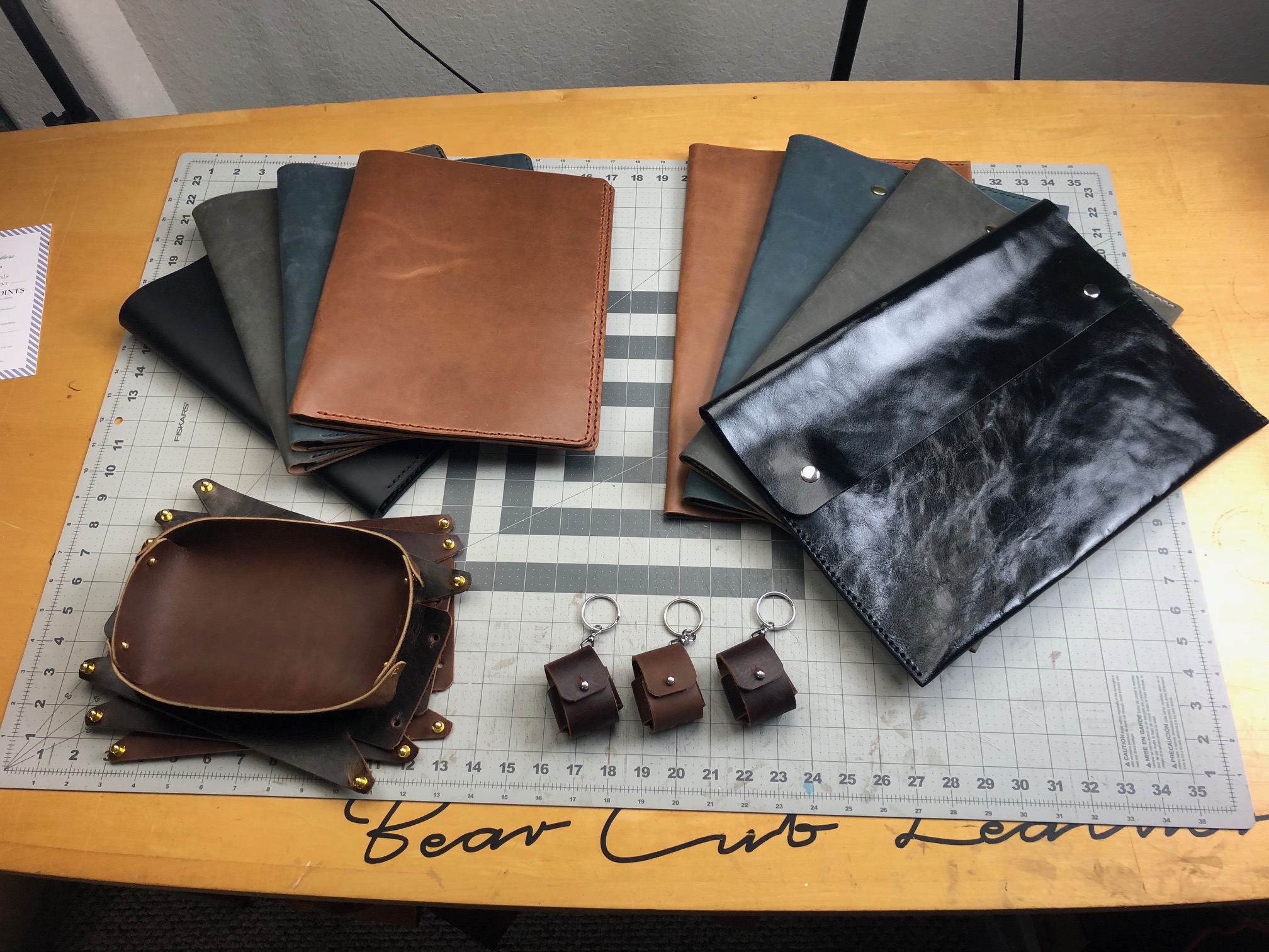 Handmade leather goods - clutches, air pod cases, valet tray