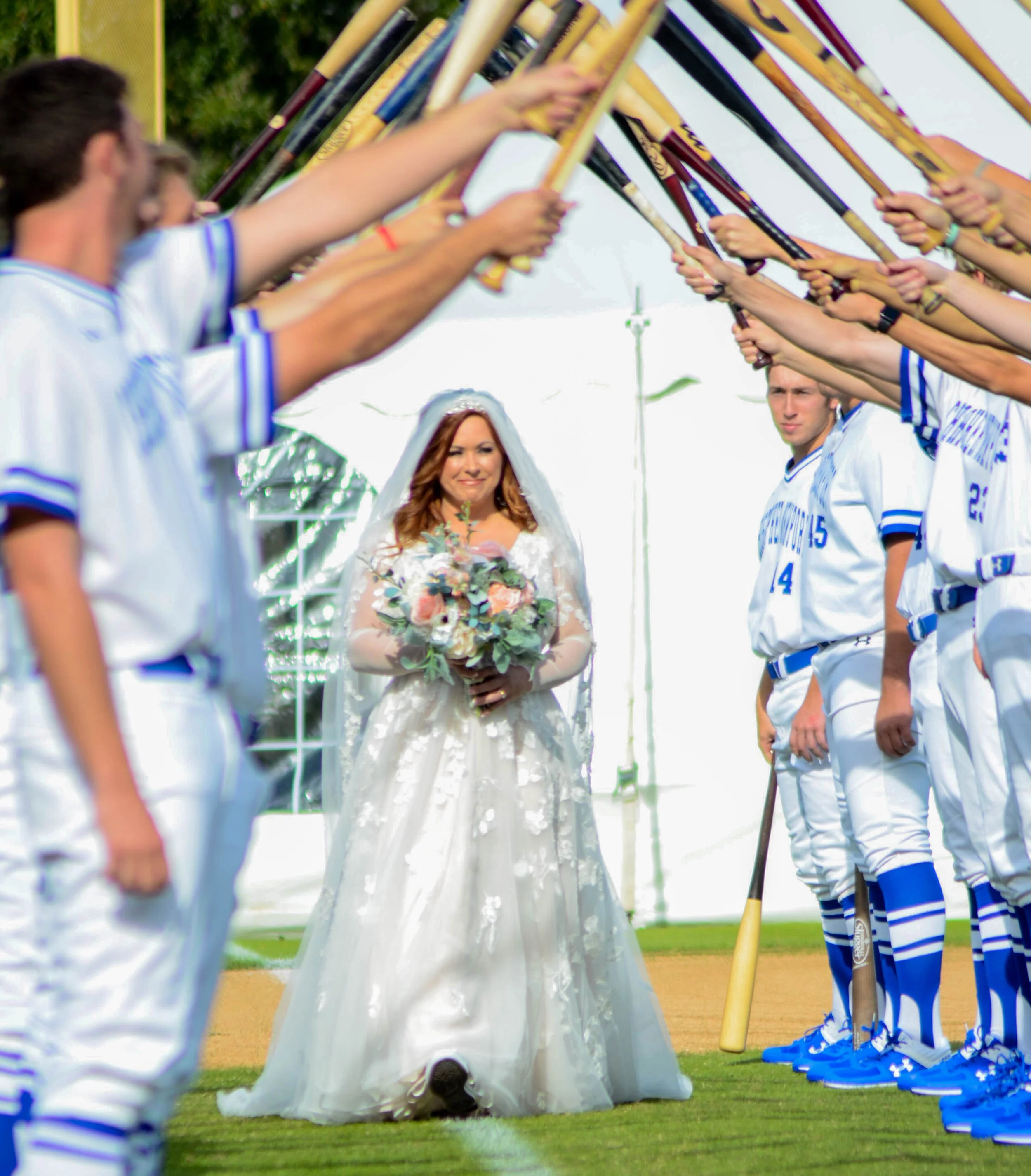  Emily Huff walks down the field of Captain’s Park at Christopher Newport University to marry Christoper Newport University’s Head Baseball Coach John Harvell on Saturday, Oct. 19, 2019.  