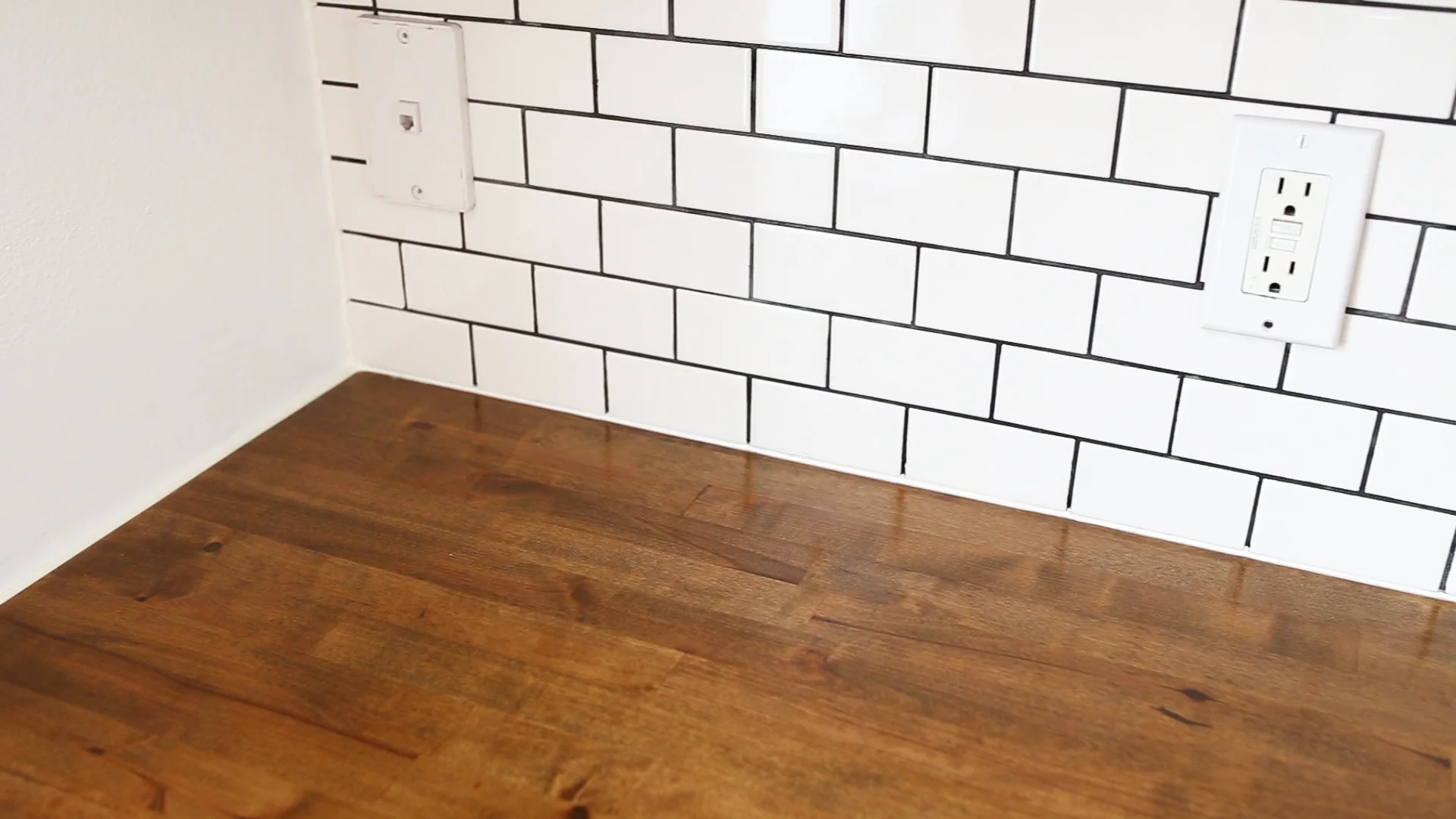 The last step to completing the countertops was to caulk the edges. We'd been wanting to add a backsplash so I added the tile backsplash before finishing with caulking the seams. And with that, the countertops were complete!