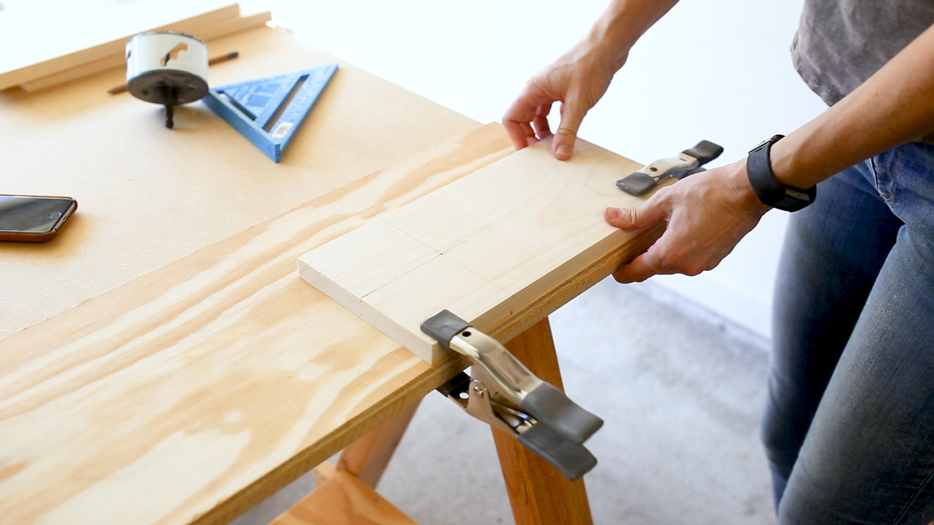 I clamped down the top board (the narrower one) and measured out where I wanted to cut my cupholder hole. I used a 3.5" hole saw on the end of my power drill to make the cut. If you have a drill press, you could use that instead. AND, if you have neither, this couch sleeve doesn't at all have to have the cupholder hole. Its just an added perk.