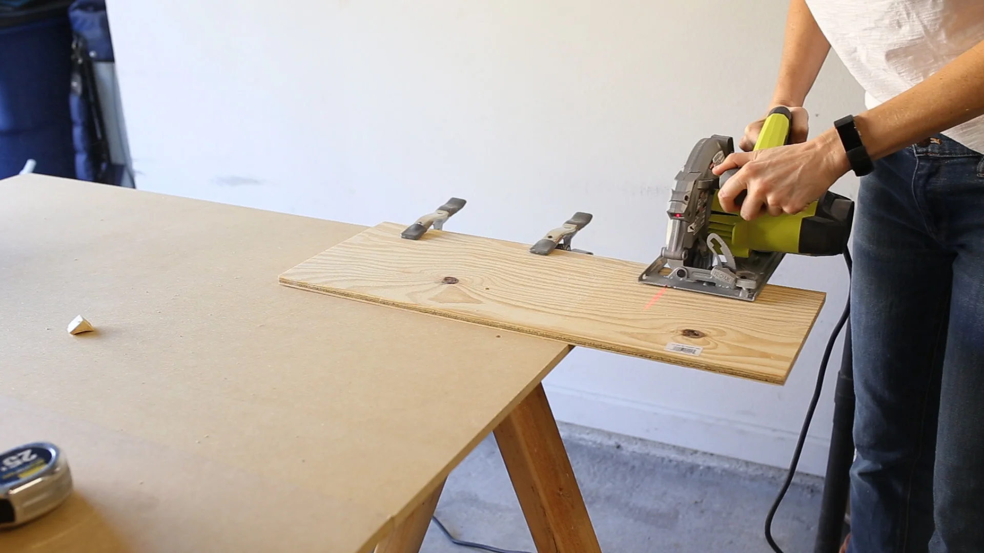 To make the bottom of the cupholder, I cut out a scrap piece of thin plywood with my circular saw that I'll glue to the underside in a later step.