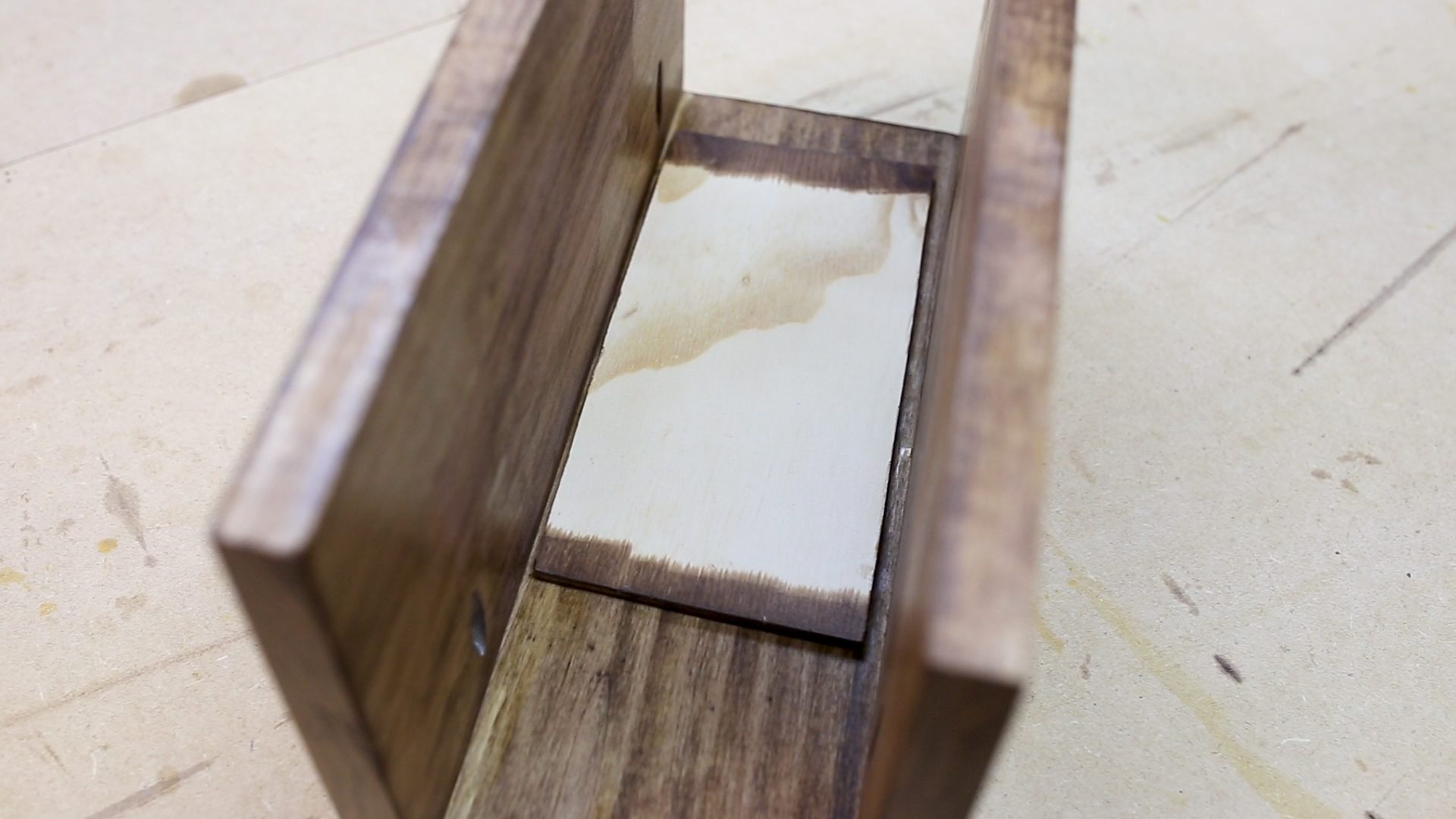 Next I added the thin piece of plywood that will be the bottom of the cupholder. I used wood glue and clamps to keep the piece in place while the glue dried. 