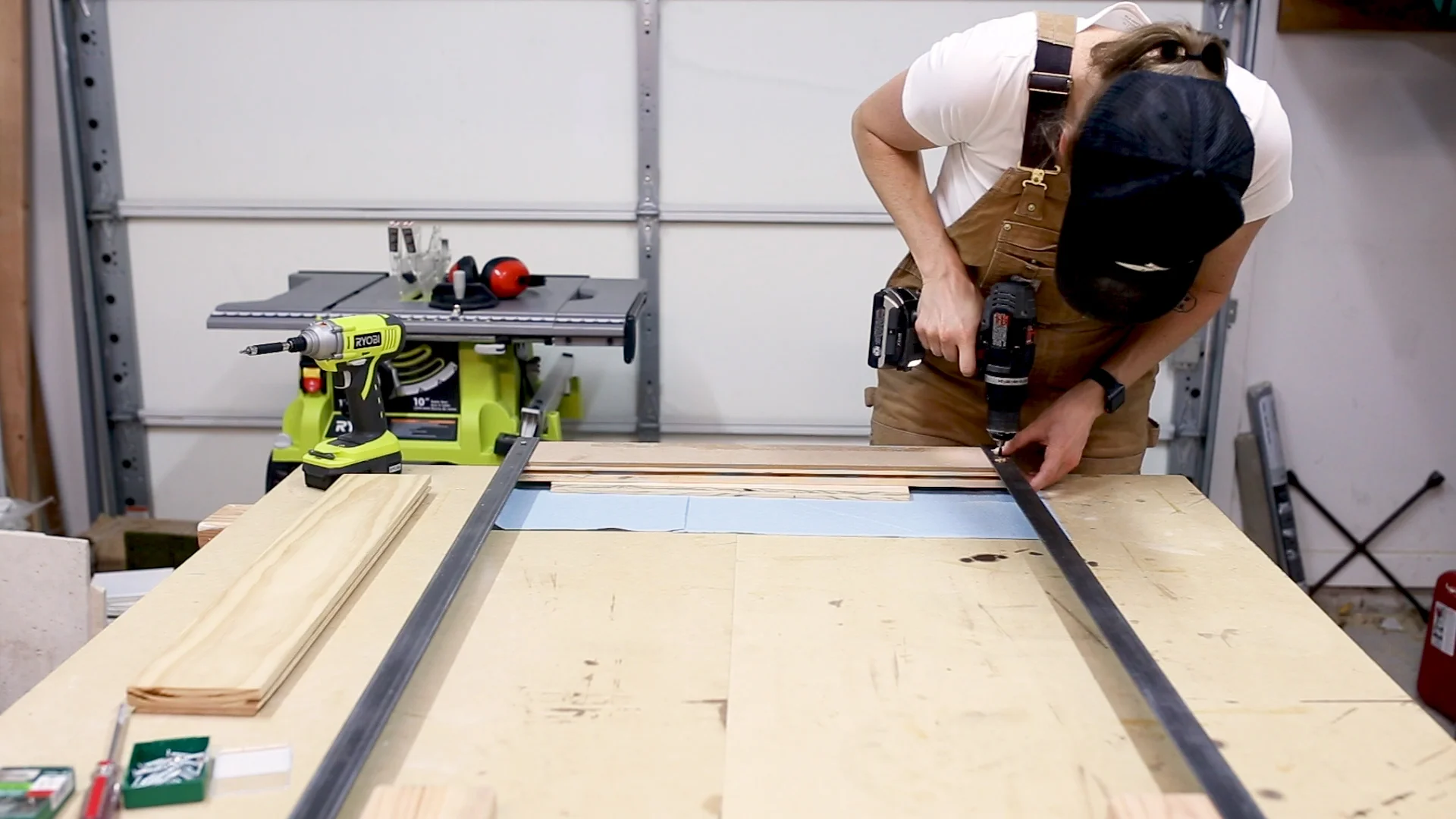 I then turned the frame upside down and placed one of the pieces of wood in between the two metal sides. I pre-drilled for my holes and then screwed the metal to the wood from the back.