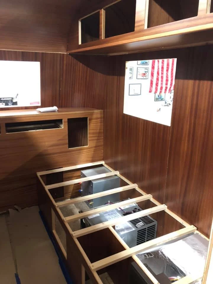 Walls mounted to the frame and interior components start to be assembled