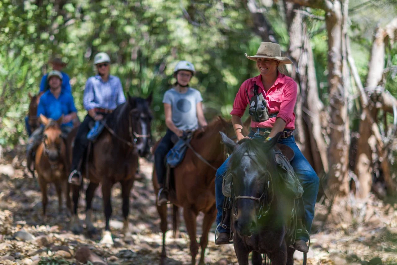 woman leading group on horse trek 