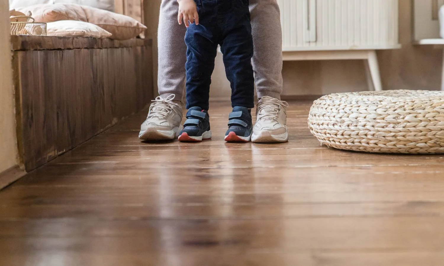 Eco-friendly flooring that's scratch-resistant, with a child learning how to walk with a parent