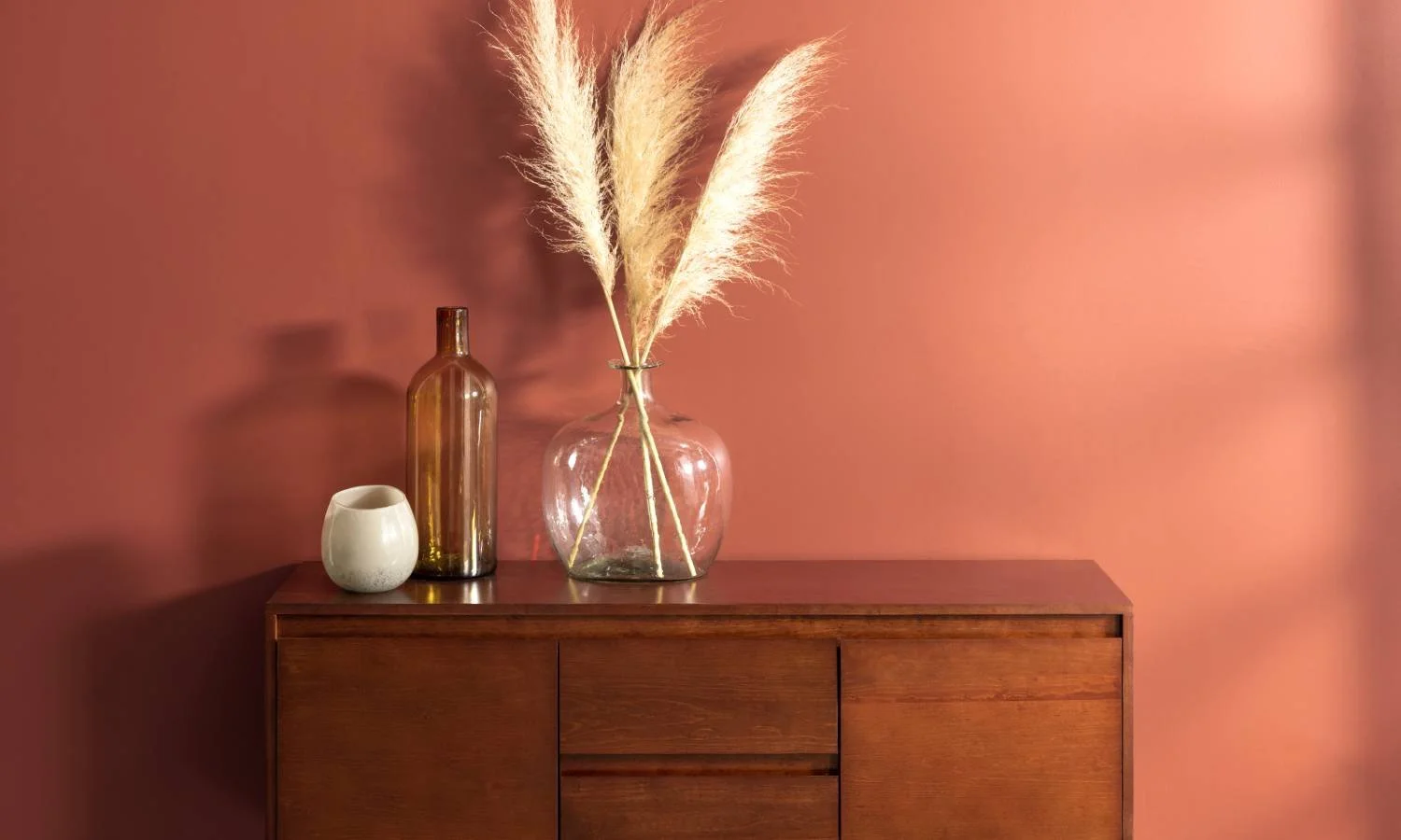 Home with a dark autumn color palette, with its walls, decorative vases, and a wooden cabinet near Hermitage, PA