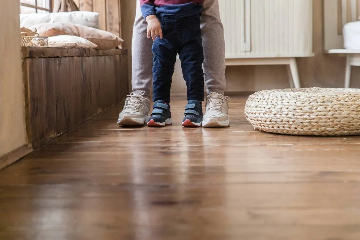 Eco-friendly flooring that's scratch-resistant, with a child learning how to walk with a parent near Hermitage, PA